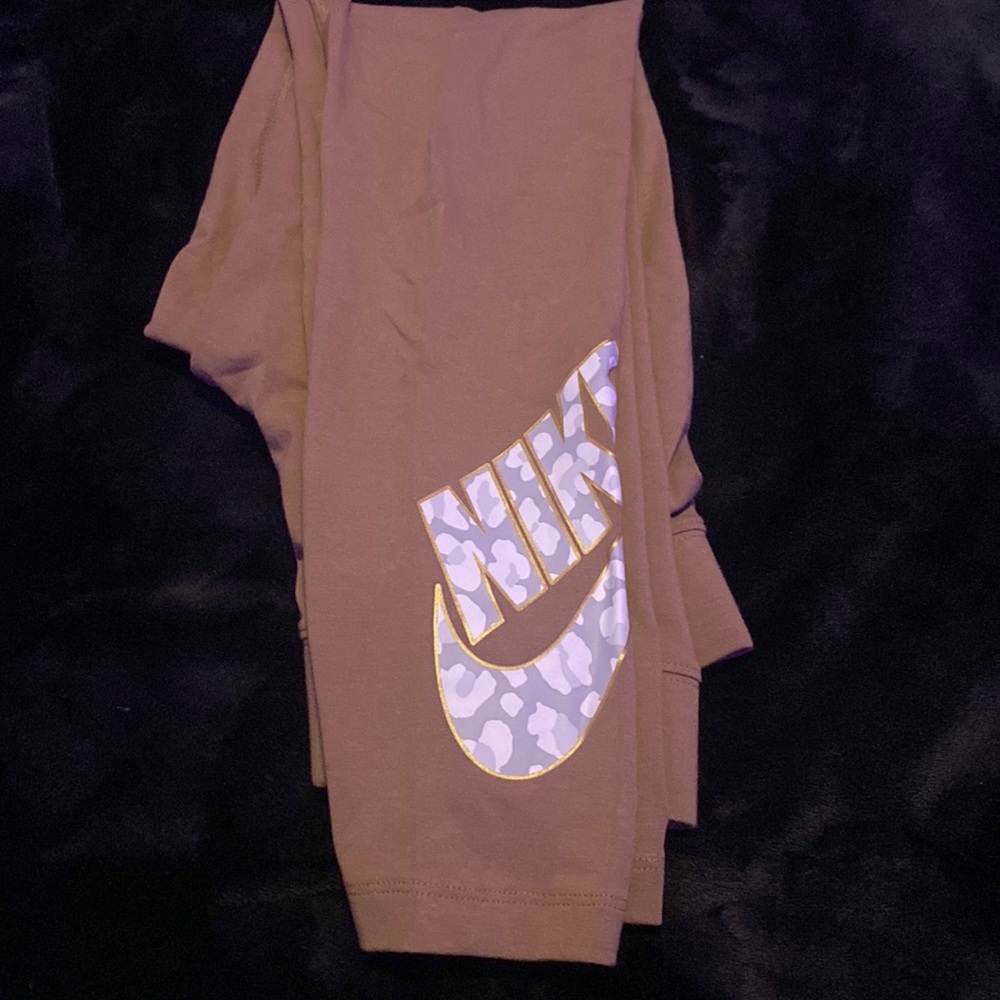 Brown Nike Leggings. Never Worn Before. Camo nike symbol with gold outline.